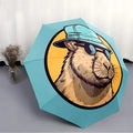 Folding umbrella Capybara wearing Fashion Glasses, blue hat, yellow background. Creative portable folding umbrella for Christm