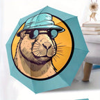 Folding umbrella Capybara wearing Fashion Glasses, blue hat, yellow background. Creative portable folding umbrella for Christm